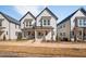 Charming two-story townhome with modern architecture, covered entrance, and beautifully landscaped front yard at 857 Athens Dr # 102, Raleigh, NC 27606