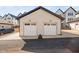 Two-car garage with white doors and dark asphalt at 857 Athens Dr # 102, Raleigh, NC 27606