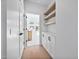 Hallway featuring hardwood floors, storage cabinets, and modern shelving at 857 Athens Dr # 102, Raleigh, NC 27606