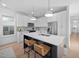 Bright kitchen with white cabinets, quartz countertops, and a large center island at 857 Athens Dr # 102, Raleigh, NC 27606