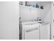 Efficient laundry room with modern appliances, storage shelves, and ample space at 857 Athens Dr # 102, Raleigh, NC 27606