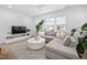 Bright living room featuring a large sectional sofa, decorative rug, and large windows with neighborhood views at 857 Athens Dr # 102, Raleigh, NC 27606
