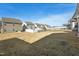 Large, grassy backyard with a black metal fence, bordered by neighboring homes at 88 Antler Steel Dr, Clayton, NC 27527