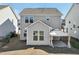 Exterior view of a two-story home with a sunroom addition and covered patio area in the backyard at 88 Antler Steel Dr, Clayton, NC 27527
