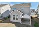 Exterior view of a two-story home with a sunroom addition and covered patio area in the backyard at 88 Antler Steel Dr, Clayton, NC 27527