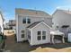 Exterior view of a two-story home with a sunroom addition and covered patio area in the backyard at 88 Antler Steel Dr, Clayton, NC 27527