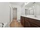 Bathroom with a double sink vanity, a large mirror, and a glass-enclosed shower, plus a view of the closet at 88 Antler Steel Dr, Clayton, NC 27527