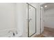 Bathroom showcasing a soaking tub and glass-enclosed shower, complete with a door to the walk-in closet at 88 Antler Steel Dr, Clayton, NC 27527