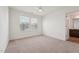 Bright bedroom with a ceiling fan and a view of the ensuite bathroom and an exterior window at 88 Antler Steel Dr, Clayton, NC 27527
