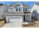 Charming two-story home with gray siding, a two-car garage, and manicured landscaping at 88 Antler Steel Dr, Clayton, NC 27527