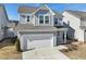 Charming two-story home with gray siding, a two-car garage, and manicured landscaping at 88 Antler Steel Dr, Clayton, NC 27527