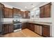 Well-equipped kitchen features stainless appliances, granite counters and ample wood cabinetry at 88 Antler Steel Dr, Clayton, NC 27527