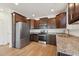 Modern kitchen featuring stainless steel appliances, granite countertops, and rich wood cabinets at 88 Antler Steel Dr, Clayton, NC 27527