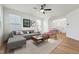 Bright, stylish living room featuring modern decor, hardwood floors, and a ceiling fan at 88 Antler Steel Dr, Clayton, NC 27527