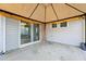 Covered patio area with outdoor lighting, shades, and access to the home through sliding glass doors at 88 Antler Steel Dr, Clayton, NC 27527