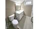Well-lit bathroom featuring a white vanity with a framed mirror, toilet, and tile flooring at 98102 Drummond, Chapel Hill, NC 27517