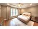 Bedroom with elegant tray ceiling, neutral walls, and windows at 98102 Drummond, Chapel Hill, NC 27517