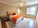 Bright bedroom features a tufted headboard, ceiling fan, hardwood floors and accent pillows at 98102 Drummond, Chapel Hill, NC 27517