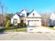 Charming two-story home with well-manicured lawn and a two car garage on a sunny day at 98102 Drummond, Chapel Hill, NC 27517