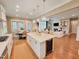 Gourmet kitchen island with wine cooler and pendant lights offering seamless flow to the dining area and living room at 98102 Drummond, Chapel Hill, NC 27517