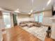 Spacious living room featuring hardwood floors, a sectional sofa, and French doors at 98102 Drummond, Chapel Hill, NC 27517