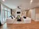 A comfortable living room boasts large windows, hardwood floors, and a cozy fireplace at 98102 Drummond, Chapel Hill, NC 27517