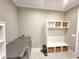 Spacious mudroom with stainless steel appliances, storage shelves, and coat hooks at 98102 Drummond, Chapel Hill, NC 27517