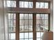 Bright sun room offers expansive windows with views of the wooded scenery and a private balcony at 98102 Drummond, Chapel Hill, NC 27517