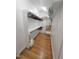 A tidy walk-in closet with wooden floors, shelving, and hanging storage at 98102 Drummond, Chapel Hill, NC 27517