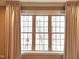 Bedroom window with neutral curtains at 98102 Drummond, Chapel Hill, NC 27517
