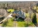 Breathtaking aerial view of estate home, lush landscaping, and mature trees at 1017 Payton Ct, Raleigh, NC 27614