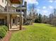 Spacious backyard with walk-out basement, stairs to the upper deck, and green lawn at 1017 Payton Ct, Raleigh, NC 27614