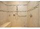 Walk-in shower with light tile, a shower seat, safety bar, and tiled accents at 1017 Payton Ct, Raleigh, NC 27614