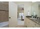 View from the bathroom into the bedroom featuring a granite countertop, and shower with tile surround at 1017 Payton Ct, Raleigh, NC 27614
