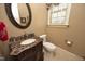 Traditional half bathroom with ornate mirror, granite countertop, and toilet at 1017 Payton Ct, Raleigh, NC 27614