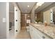 Bathroom featuring a granite countertop vanity, tile floors, and a glass-enclosed shower at 1017 Payton Ct, Raleigh, NC 27614