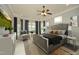 Staged bedroom featuring a large window, neutral carpeting, ceiling fan and gray color scheme at 1017 Payton Ct, Raleigh, NC 27614