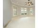 Bright bedroom with neutral walls, three large windows, and neutral carpeting at 1017 Payton Ct, Raleigh, NC 27614