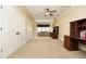 Spacious bonus room featuring a ceiling fan, built-in desk, and large window at 1017 Payton Ct, Raleigh, NC 27614