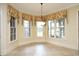 Bright breakfast nook featuring large windows, decorative valances, and neutral tile flooring at 1017 Payton Ct, Raleigh, NC 27614