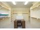 Large walk-in closet featuring wood desk, open shelving and hanging rods at 1017 Payton Ct, Raleigh, NC 27614