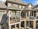 Relaxing outdoor living space on a beautiful two-level deck and patio with brick pillars and ample seating at 1017 Payton Ct, Raleigh, NC 27614