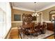 Formal dining room featuring an oval table with seating for eight, hardwood floors, and elegant lighting at 1017 Payton Ct, Raleigh, NC 27614