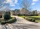 Long driveway to the garage, with mature landscaping and greenery on either side at 1017 Payton Ct, Raleigh, NC 27614