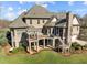 Spacious brick home with an outdoor deck, covered gazebo, and a well-manicured lawn at 1017 Payton Ct, Raleigh, NC 27614