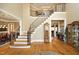 Grand foyer featuring hardwood floors, a staircase with iron railings, and elegant trim work at 1017 Payton Ct, Raleigh, NC 27614