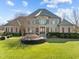 Impressive brick home with stone accents, manicured lawn, and mature landscaping offers stately curb appeal at 1017 Payton Ct, Raleigh, NC 27614