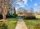 Beautifully landscaped front yard with stone pathway leading to the grand home at 1017 Payton Ct, Raleigh, NC 27614