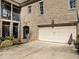 Attached two-car garage with a basketball hoop, and brick exterior at 1017 Payton Ct, Raleigh, NC 27614