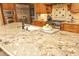Kitchen island featuring granite countertops, a stainless steel sink, and modern fixtures at 1017 Payton Ct, Raleigh, NC 27614